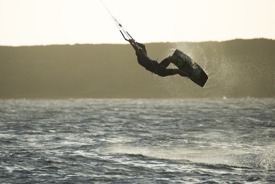 kiters in jumping with surfboard