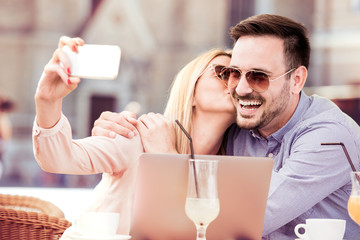 Love couple taking a selfie during coffee break.