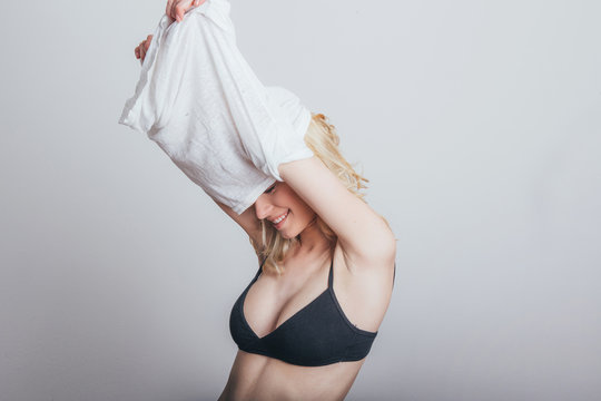 Woman taking shirt off.