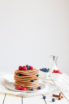 Fresh pancakes with blackberries, raspberries and maple syrup