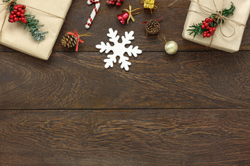 Table top view of the Merry Christmas & Happy new year concept background.Essential festive decorations on modern brown wood.Copy space for creative  text or wording.Design mock up and template. © osabee