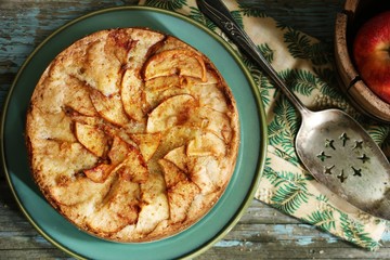 Homemade German apple cake on rustic blue wooden background,Top Down view / Thanksgiving dessert