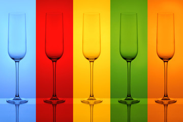 empty sparkling wine glasses on a colourful background