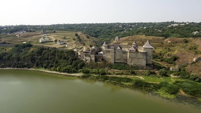 Aerial view of Khotyn medieval castle on the green hill above the river.