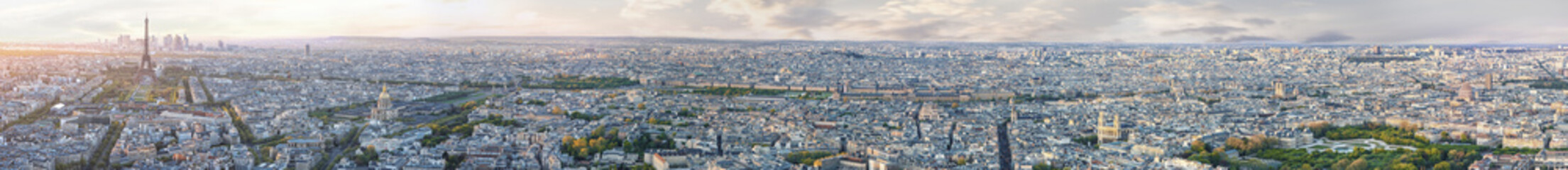 Panoramic aerilal view of whole Paris from Eiffel tower to Notre Dame cathedral at sunset. Copy space in sky.