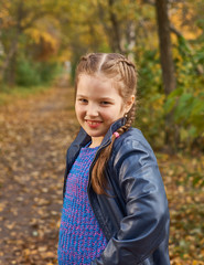 little girl having fun on beautiful autumn