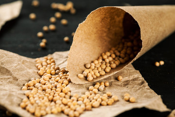 Paper bag with white mustard seeds closeup