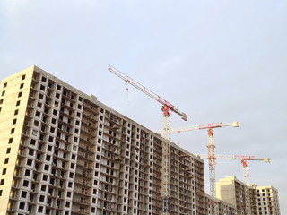 Fototapeta na wymiar Building construction, tower cranes, low angle