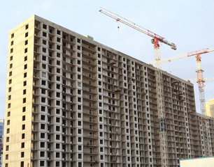 Fototapeta na wymiar Building construction, tower cranes, low angle