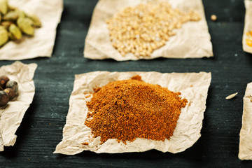 Ground red pepper among other spices on a black table