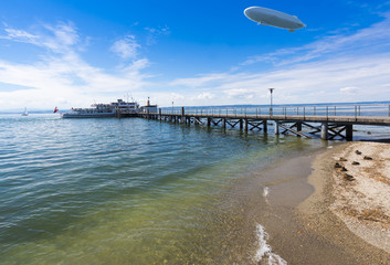 Zeppelin and Excursion boat at the landing stage  of Hagnau - Hagnau, Lake Constance, Baden-Wuerttemberg, Germany, Europe © karlo54
