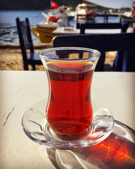 turkish tea on wooden table next to sea