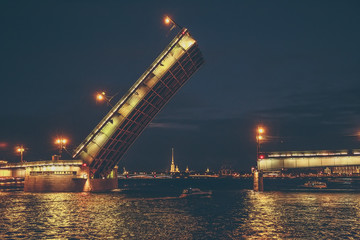 Fototapeta na wymiar Saint Petersburg, bridging of bridge at night, drawbridge on Neva river at White nights