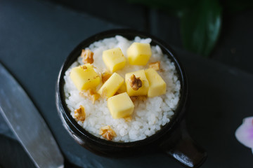 Mango and rice over black slate board.