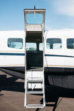 A wide open entrance of a small aircraft.