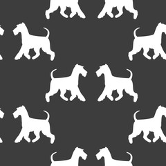 Seamless pattern with white silhouettes of terriers.