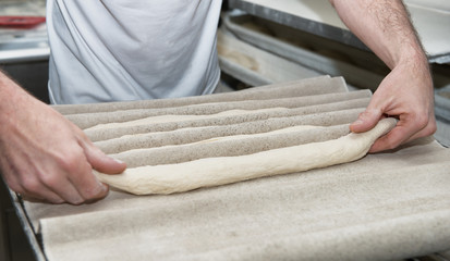baker prepares bread dough, close up on his hands