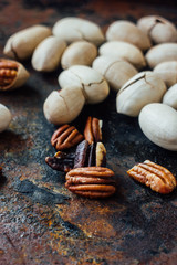 Pecan nuts on black rustic board.
