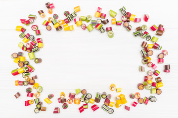 A round frame made of colored caramel candies