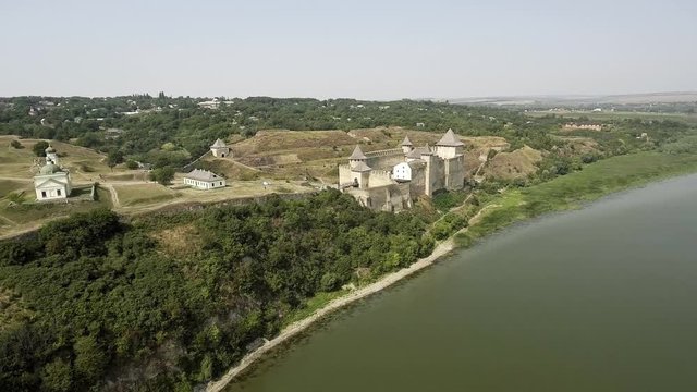 Aerial view of Khotyn medieval castle on the green hill above the river.