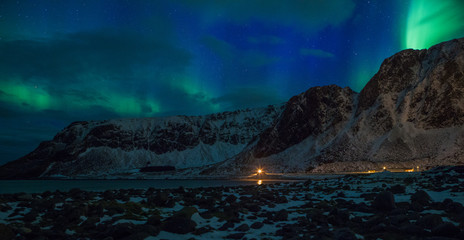 Fototapeta na wymiar Northern lights (Aurora borealis) over the mountains. Norway, Lofoten