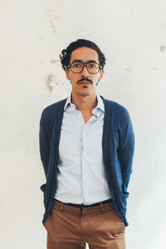 Indoor Portrait of Young Well-Dressed Latin Man With Glasses