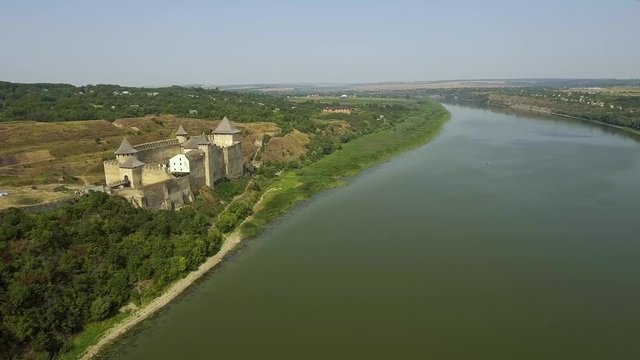 Aerial view of Khotyn medieval castle on the green hill above the river.