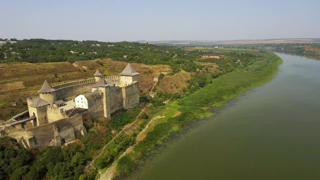 Aerial view of Khotyn medieval castle on the green hill above the river.