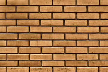 A wall made from golden bricks. Brickwork texture