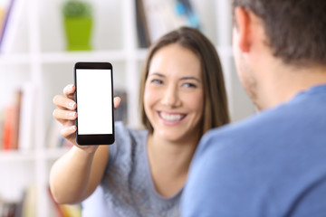 Woman showing phone screen to a friend