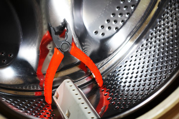 Stainless steel drum of a washing machine. Tools for repair.