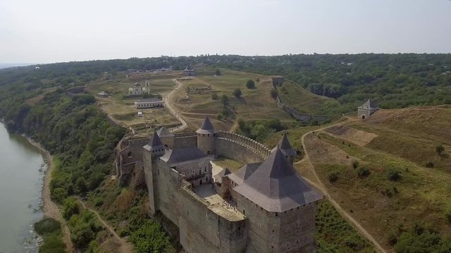 Aerial view of Khotyn medieval castle on the green hill above the river.