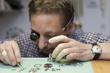 Clockmaker working in workshop