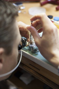 Clockmaker working in workshop
