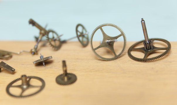 Parts of deconstructed watch lying on table