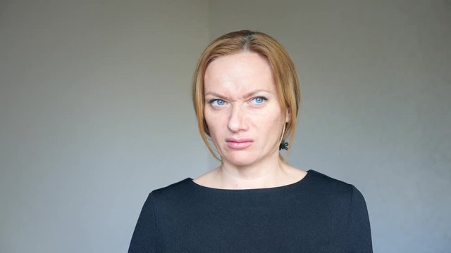 4k. Close up of beautiful blonde woman with bright blue eyes. portrait of a young woman. body language and gestures. she is disgusted