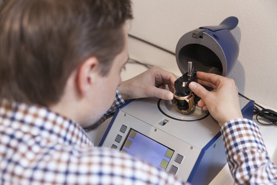 Clockmaker working in workshop