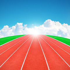 Running track in sunrise with blue sky and clouds