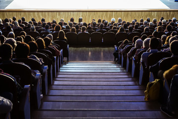 Naklejka premium People in the auditorium during the performance. A theatrical production.