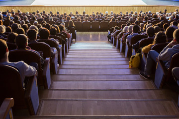 Fototapeta premium People in the auditorium during the performance. A theatrical production.