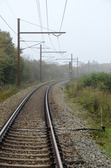 Fototapeta na wymiar Electric railway with signal on red.