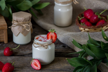 Organic yougurt in jar with strawberry. Fresh strawberry with yogurt