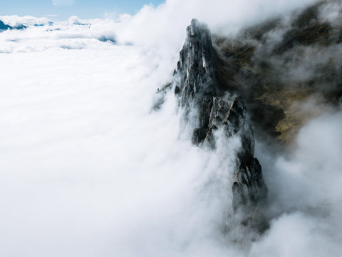 Mountain range in Switzerland cradled with thick clouds during autumn