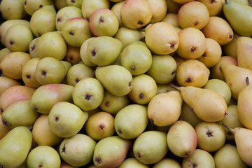 Pears background. Lots of fresh pears on a market or grocery store.