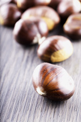 Chestnuts over wooden table