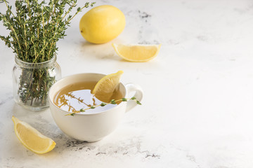 Green tea with lemon and thyme, copy space