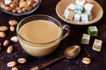 Coffee with milk, pistachios and turkish delight