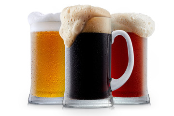 Mug collection of frosty dark red and light beer with foam isolated on a white background
