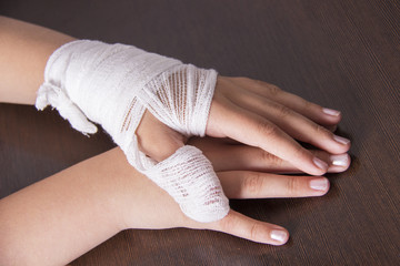 Bandaged woman's hand, hand injury, bandage bandage