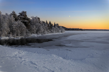 Winter lake in Finland at sunset